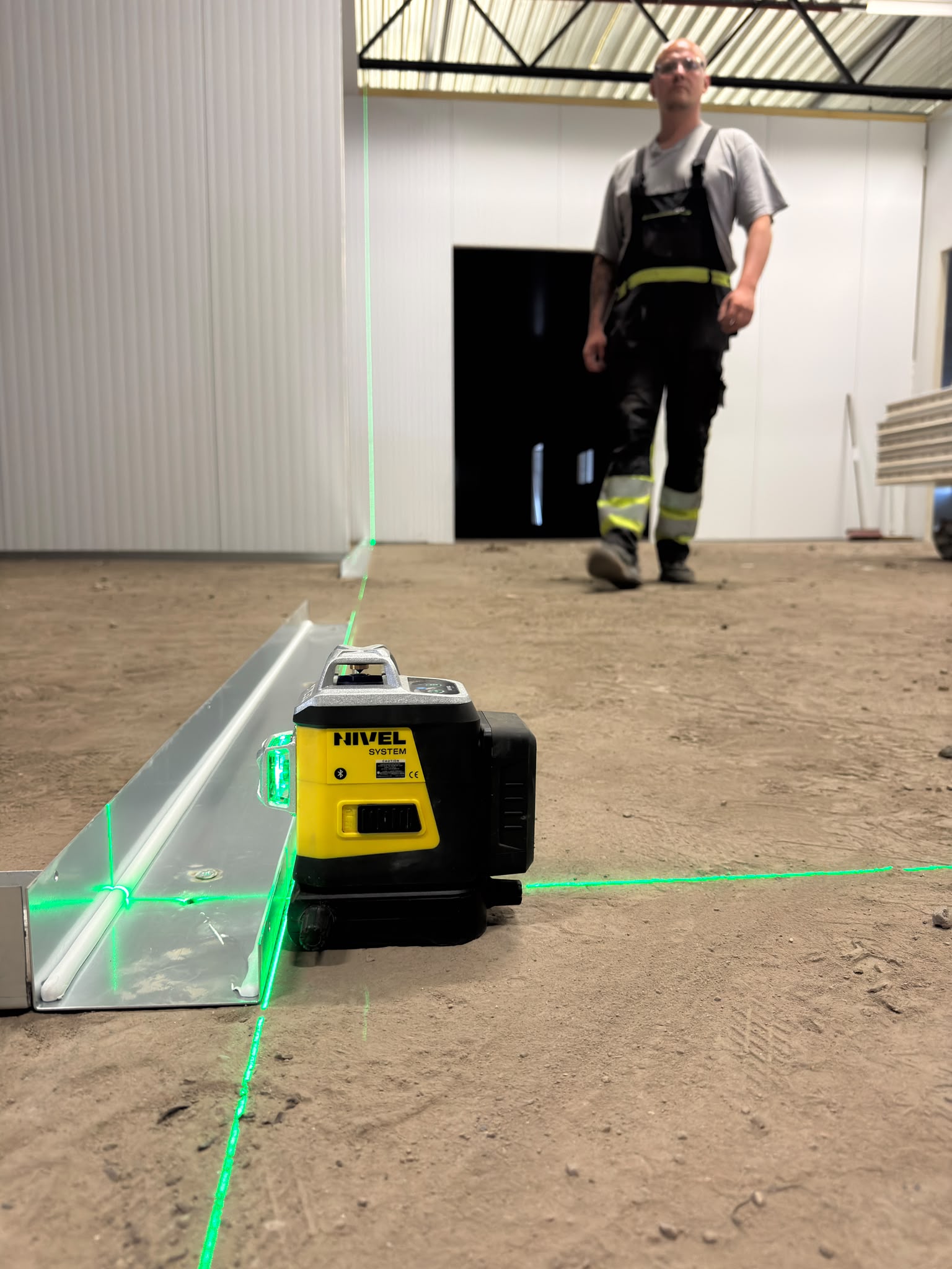 Setting out the wall installation line with a laser.
